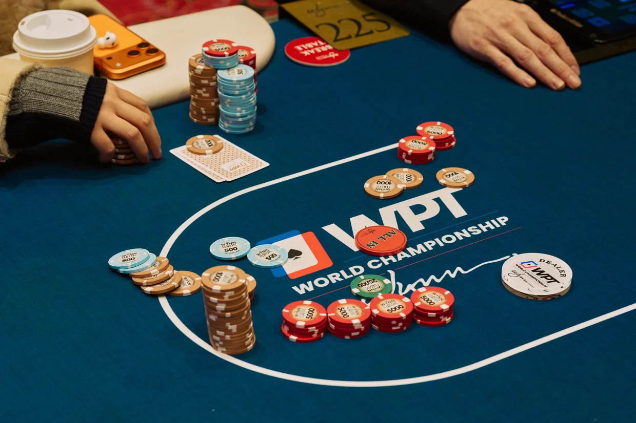 Wynn Las Vegas chips and hole cards on the felt at a WPT® World Championship poker table.