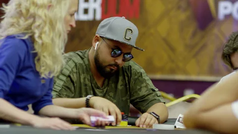 poker player wearing glasses at the table