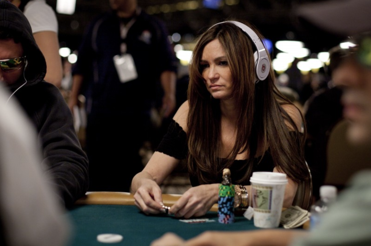 beth shak with headphones playing poker